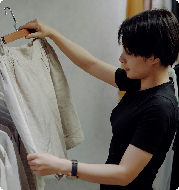 Image of a person inspecting clothes for quality control